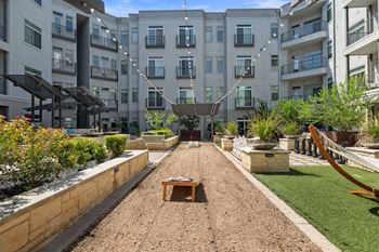 Game courtyard with community grills, bocce ball court, and life size chess board
